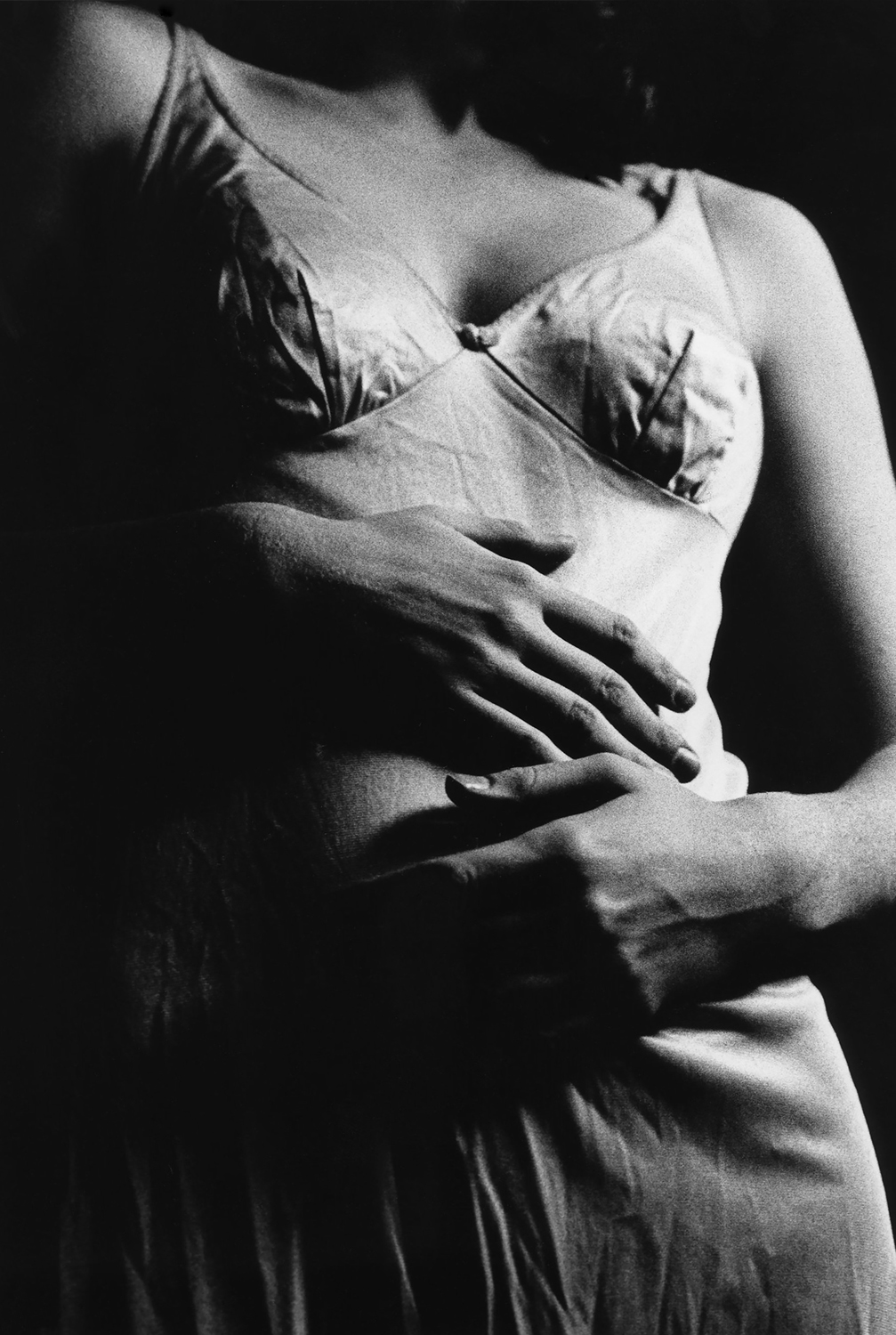 Black and white photo of woman's torso against a black background. Photo by Lydia Norton titled Cramped.
