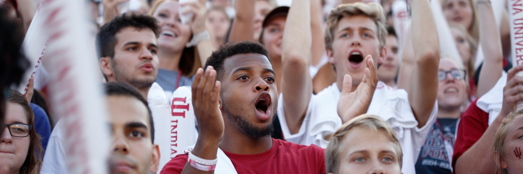 Students cheering with IU gear at the freshman pep rally in 2017