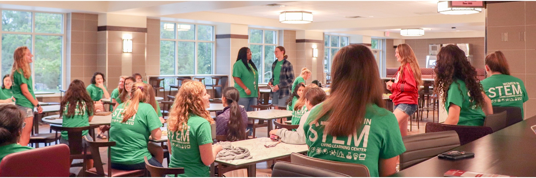 Students take part in a Women in STEM event held in a dining hall
