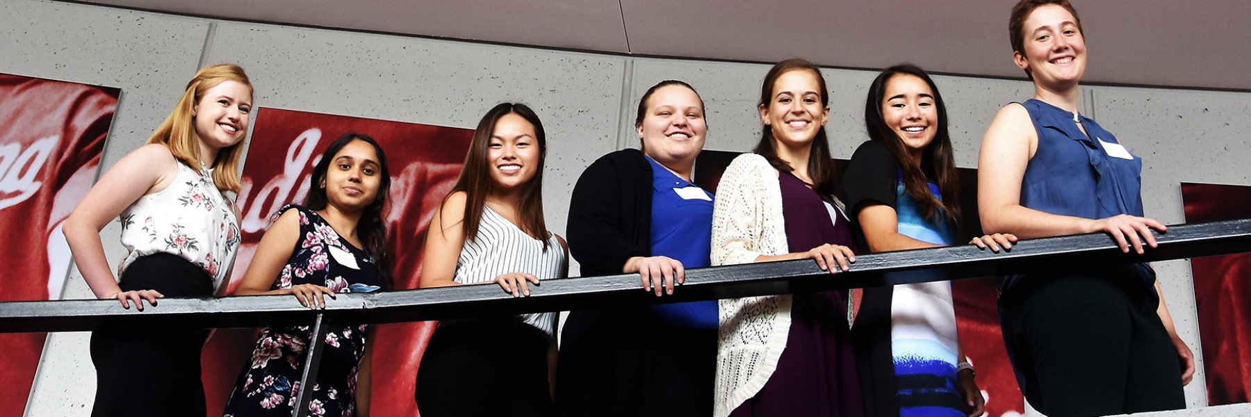 Women students in professional attire standing together and smiling